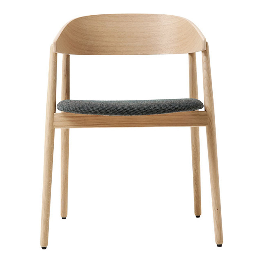 Light wood chair with a curved backrest and dark gray upholstery on the seat. Simple, modern design with natural colors.