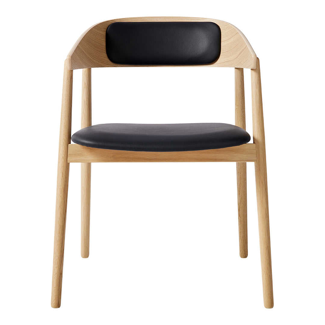 Modern chair with natural wood finish and sleek black leather seat and backrest. Simple, elegant design for any decor.