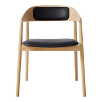 Modern chair with natural wood finish and sleek black leather seat and backrest. Simple, elegant design for any decor.