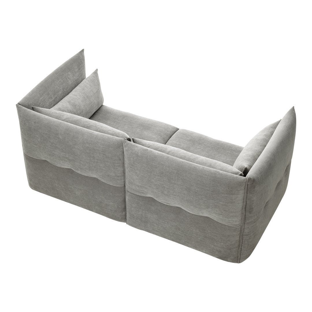 Gray modular couch with smooth panels and subtle wavy patterns, ideal for modern decor.
