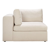 Beige upholstered corner sofa with a minimalist design, featuring a smooth fabric texture and simple, muted coloration.