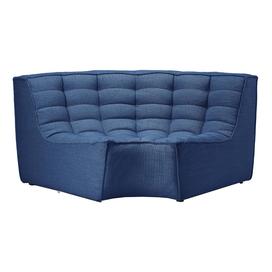 Blue tufted corner sofa with a textured fabric and modern design, featuring deep navy shades and a curved silhouette.