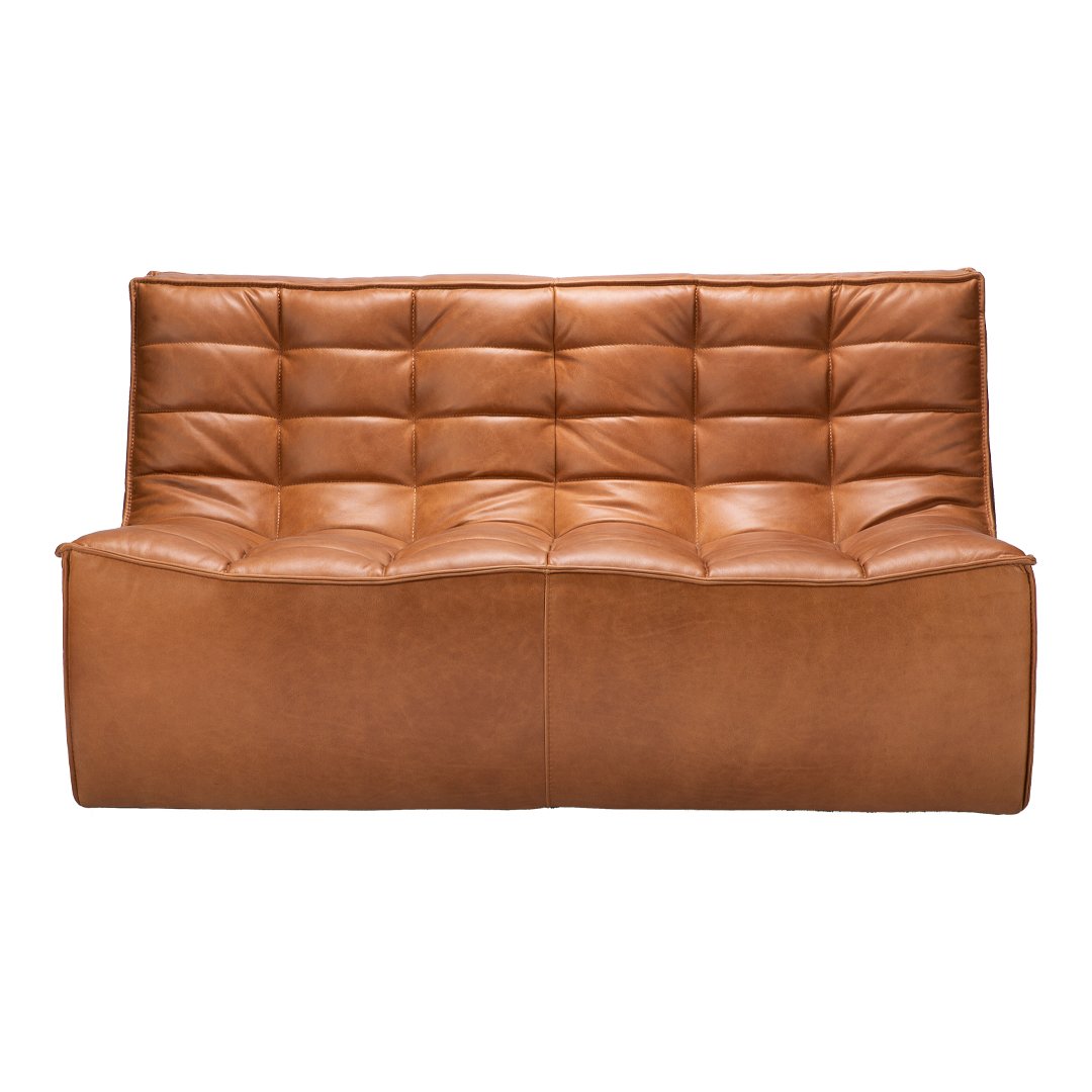 Brown tufted leather sofa with a smooth, contemporary design, featuring a sleek silhouette and rich texture.