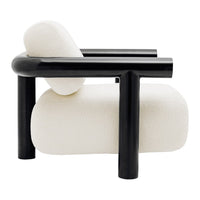 Cream boucle fabric chair with sleek black tubular frame, showcasing modern design and contrasting textures.