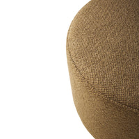 Textured round ottoman in warm brown fabric, showcasing a subtle, woven pattern on a neutral background.