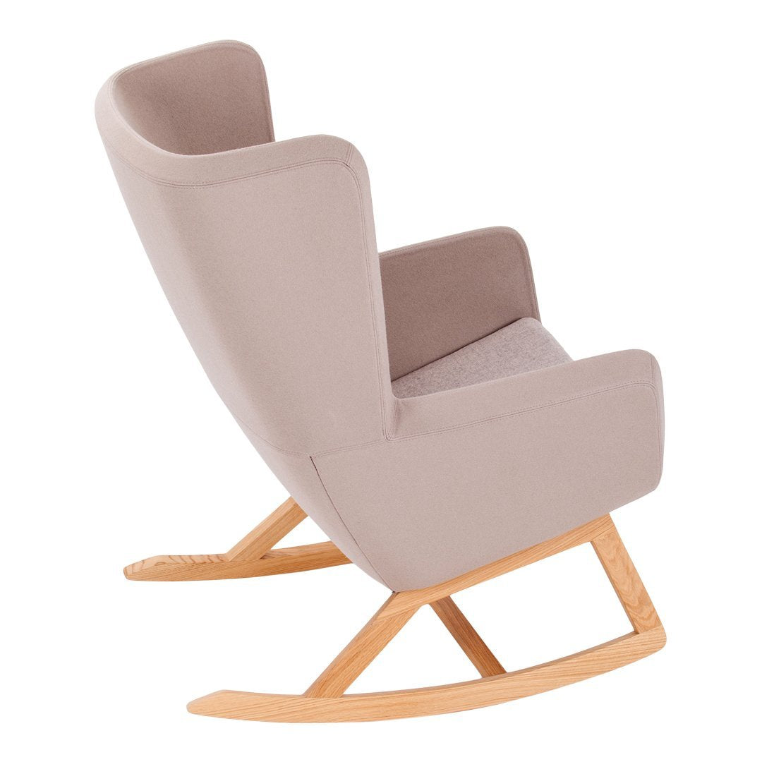 Soft beige rocking chair with a smooth fabric finish and light wooden base, featuring a minimalist design.