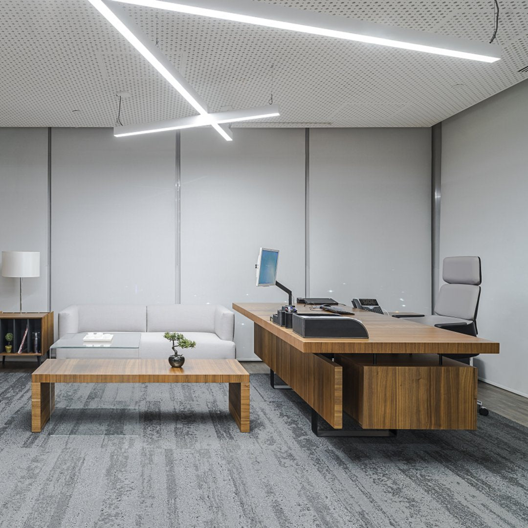 Modern office with gray walls, wooden furniture, and a minimalist design featuring sleek lines and soft textures.