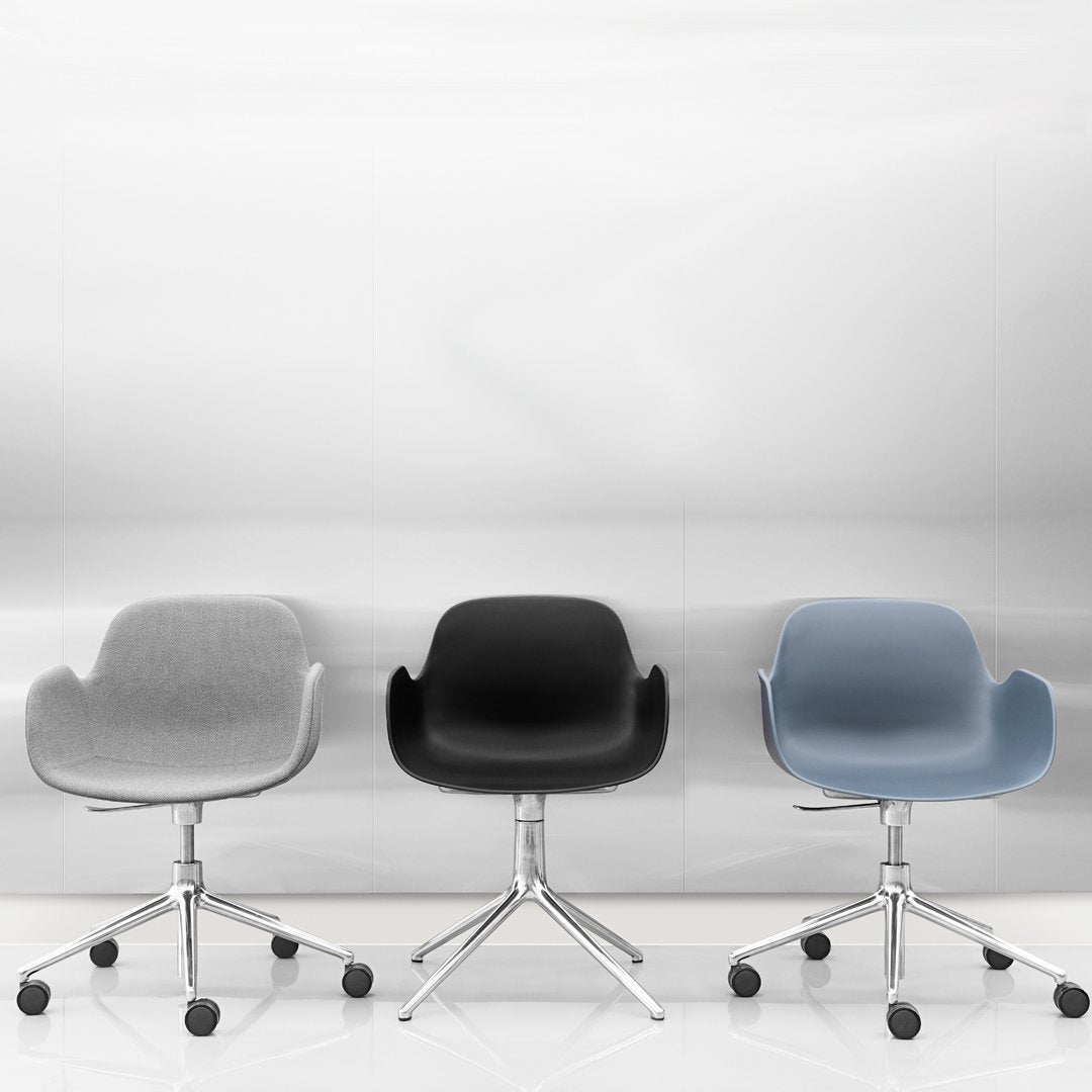 Set of three modern office chairs in gray, black, and light blue with sleek chrome bases and minimalist design.