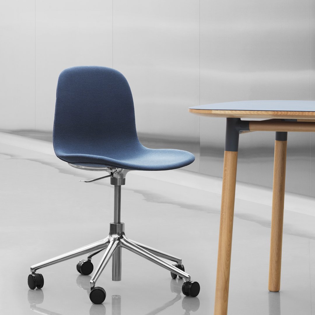 Blue ergonomic chair with a smooth surface and chrome base, set against a minimalist background.