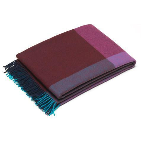 Multicolored blanket featuring burgundy, purple, and teal with a geometric pattern and fringed edges.