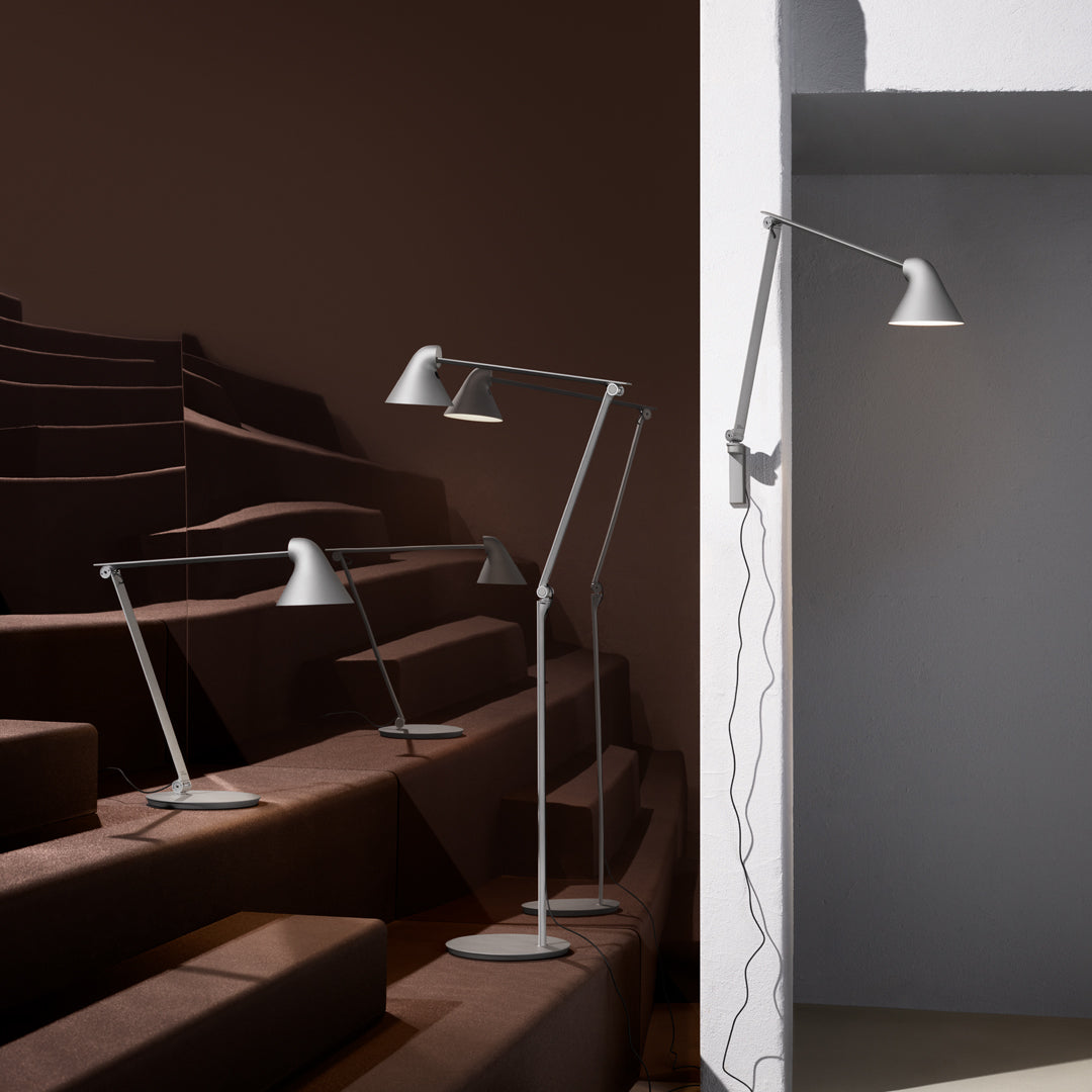 Modern gray lamps with sleek lines and minimalist design, set against dark and light backgrounds.