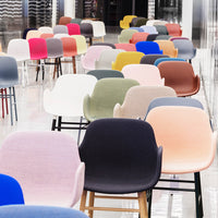 "Colorful modern chairs in various shades: pink, blue, green, beige, and gray, featuring smooth, textured patterns."