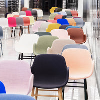Colorful array of modern chairs featuring pink, blue, green, white, and gray hues with various textured patterns.