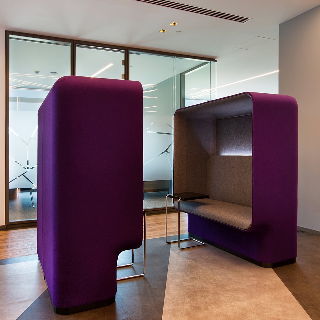 Purple fabric booth with a sleek gray interior, designed for modern office spaces. Stylish and contemporary look.
