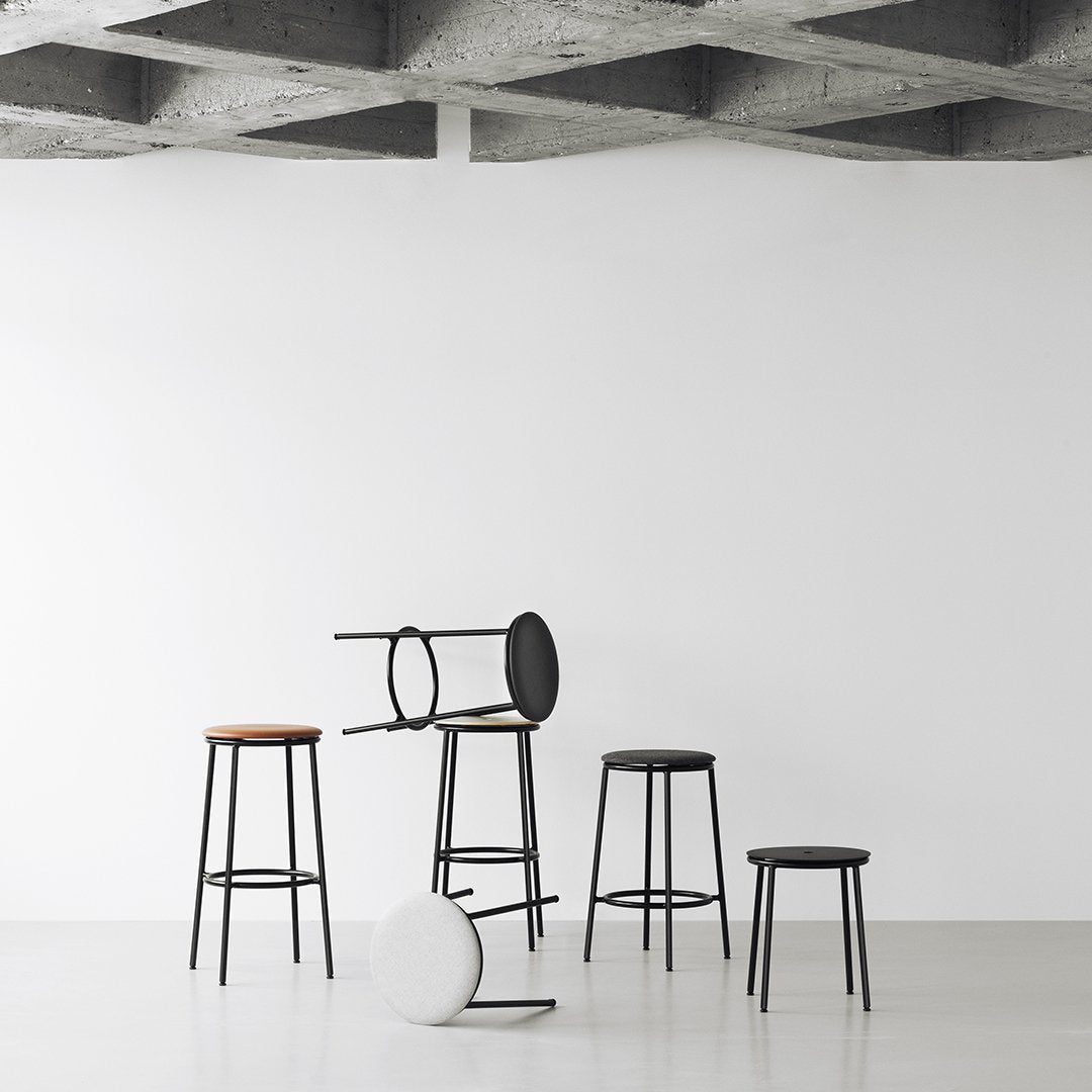 Stylish modern bar stools in black, white, and natural wood finishes, featuring sleek minimalist designs.