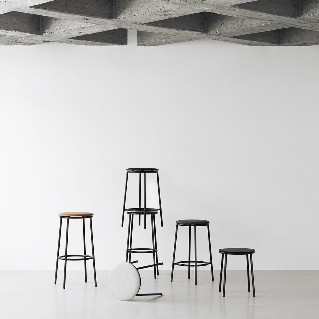 "Set of minimalist bar stools in black and natural wood with clean lines on a white background."