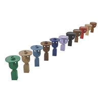 Colorful decorative stools in green, brown, purple, grey, black, and red with playful patterns, ideal for modern decor.