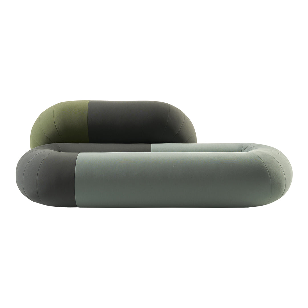 Modern couch in soft green, dark green, and muted gray tones with smooth, rounded shapes and minimalistic design.