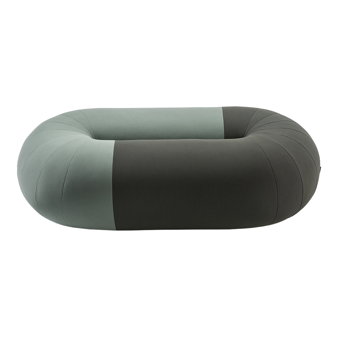 Stylish oval pet bed with a two-tone design featuring muted gray and soft green hues.