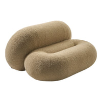 Beige plush double curved pillow with a soft, textured surface, perfect for modern home decor.