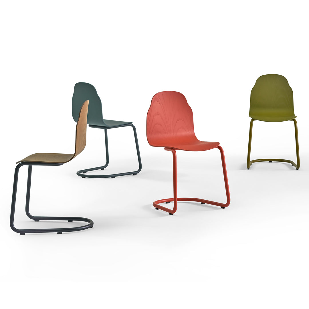 Colorful modern chairs in muted green, orange, and olive, featuring sleek, minimalistic patterns and stylish designs.