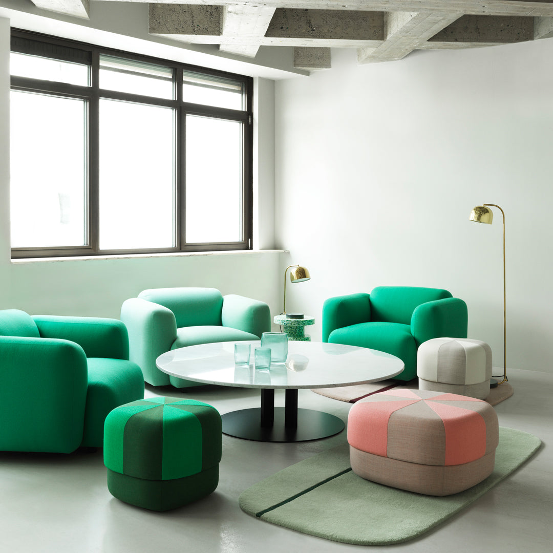 Modern seating in vibrant green and soft pastel pink, with geometric patterns for a stylish living space.