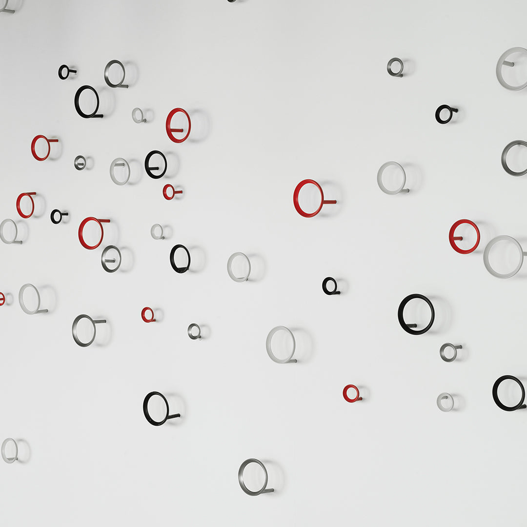 Colorful abstract wall decor featuring red, black, and white circular patterns in varying sizes.