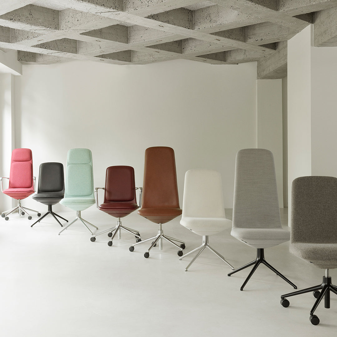 Collection of stylish chairs in pastel pink, mint green, brown, white, and gray upholstery with sleek metal bases.