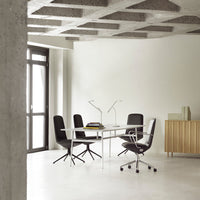Modern office set featuring black chairs, a white table, and a neutral-toned accent cabinet against a light backdrop.