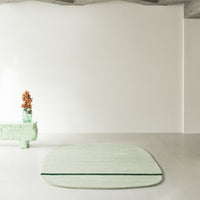 Mint green rug with a soft, smooth texture, perfectly complementing a minimalist interior with neutral tones.