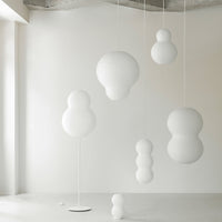 White modern pendant lights with various bubble shapes, adding a minimalist touch to interior decor.