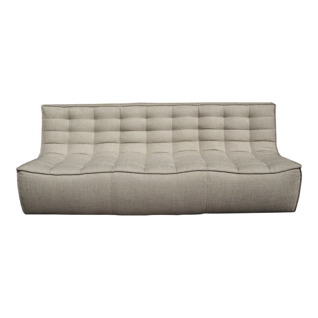 Light beige tufted sofa with a smooth texture and subtle trim for a modern, minimalist aesthetic.