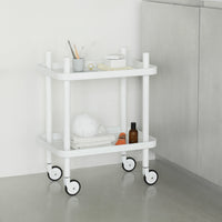 White metal rolling cart with clean lines and a minimalist design, featuring simple circular patterns on the wheels.