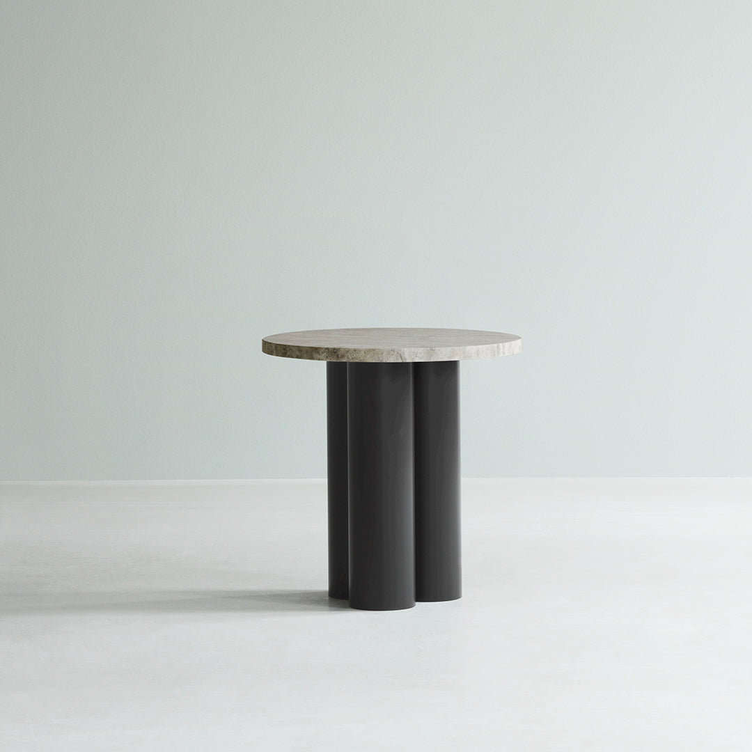 Round marble top table with black cylindrical legs, featuring a sleek modern design and neutral color palette.