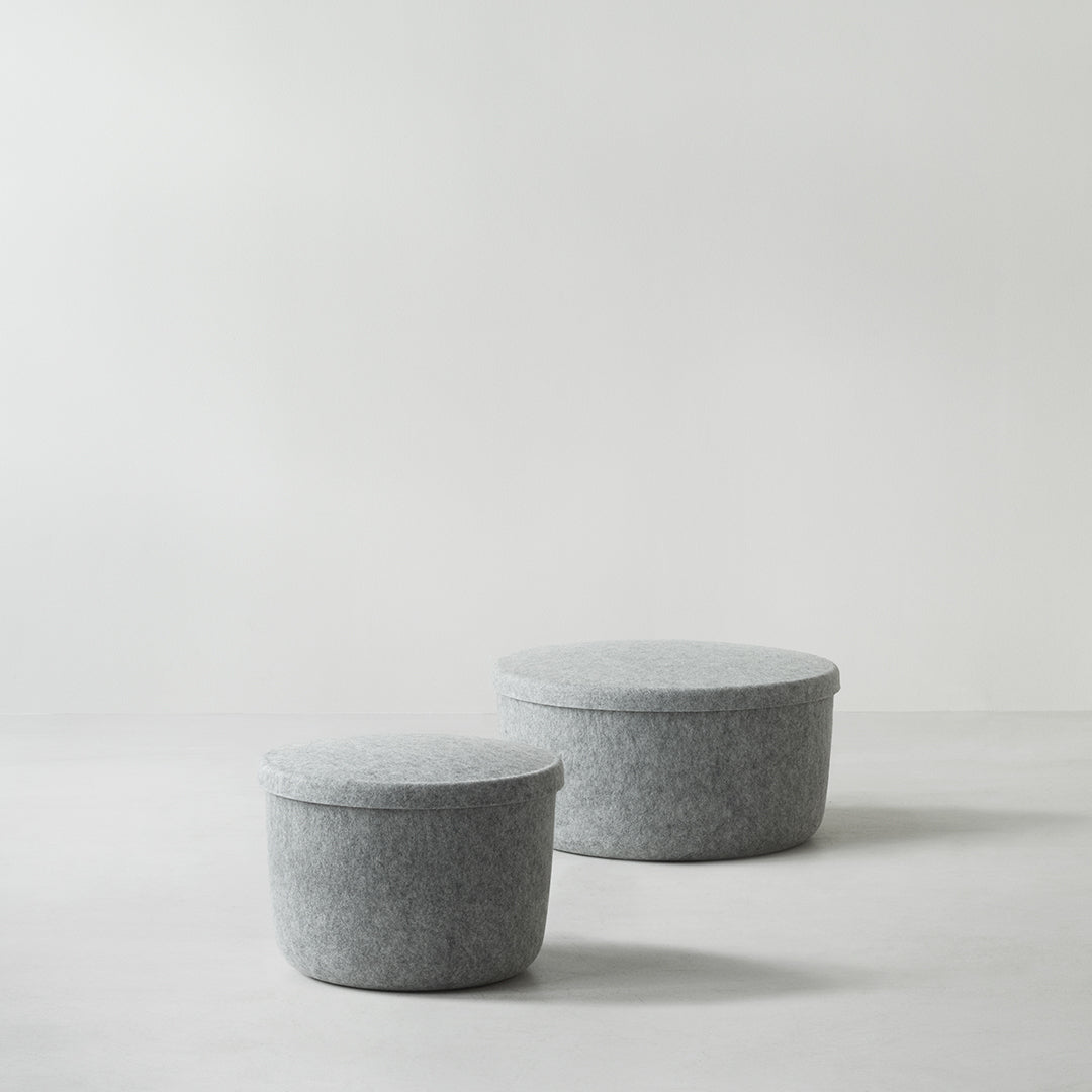 Gray felt storage baskets with smooth, round shapes, perfect for minimalist decor.