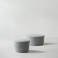 Gray felt storage baskets with smooth, round shapes, perfect for minimalist decor.