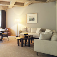 Cozy living room featuring neutral tones, soft textures, and simple geometric patterns in furnishings.