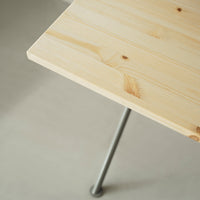 Light natural wood table surface with visible grain pattern, contrasted by sleek metal legs.