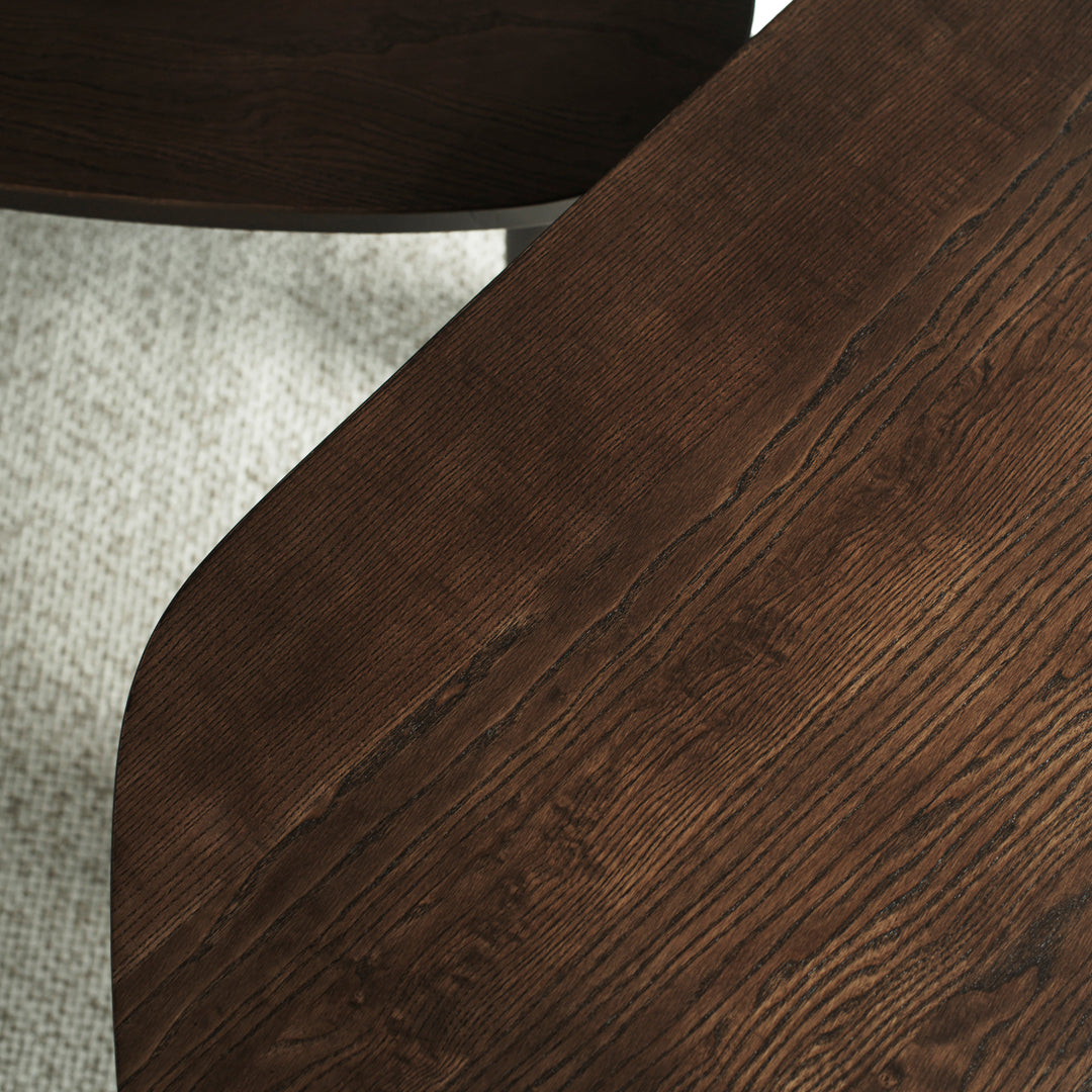 Brown wooden tabletop with a textured finish, contrasting against a light gray patterned surface.