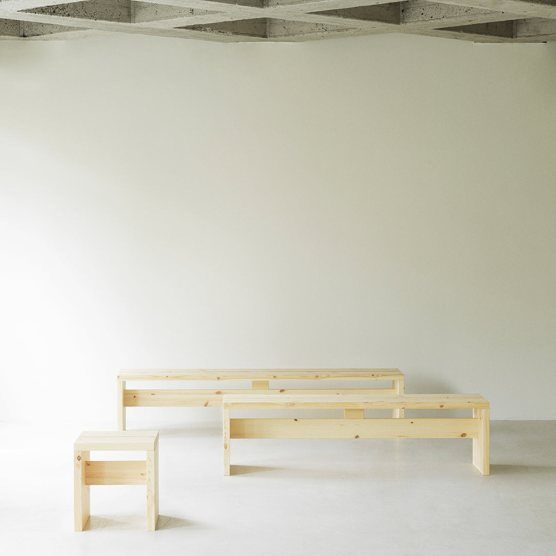 "Light natural wood benches in minimalist design, showcasing smooth grains and clean lines against a neutral backdrop."