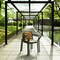 Black metal chair with wooden slats, featuring natural tones, set in a tranquil outdoor pathway.