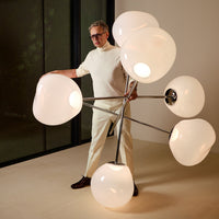 Modern lamp with sleek silver base and oversized, frosted white glass shades in a cluster design.