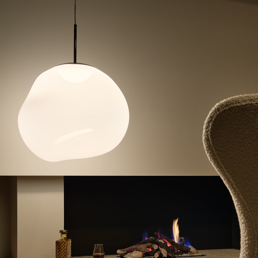 White, organic-shaped pendant light against a neutral wall, creating a soft and modern aesthetic.