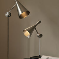 "Modern metallic lamps in sleek silver finish, featuring conical shades and minimalist design."