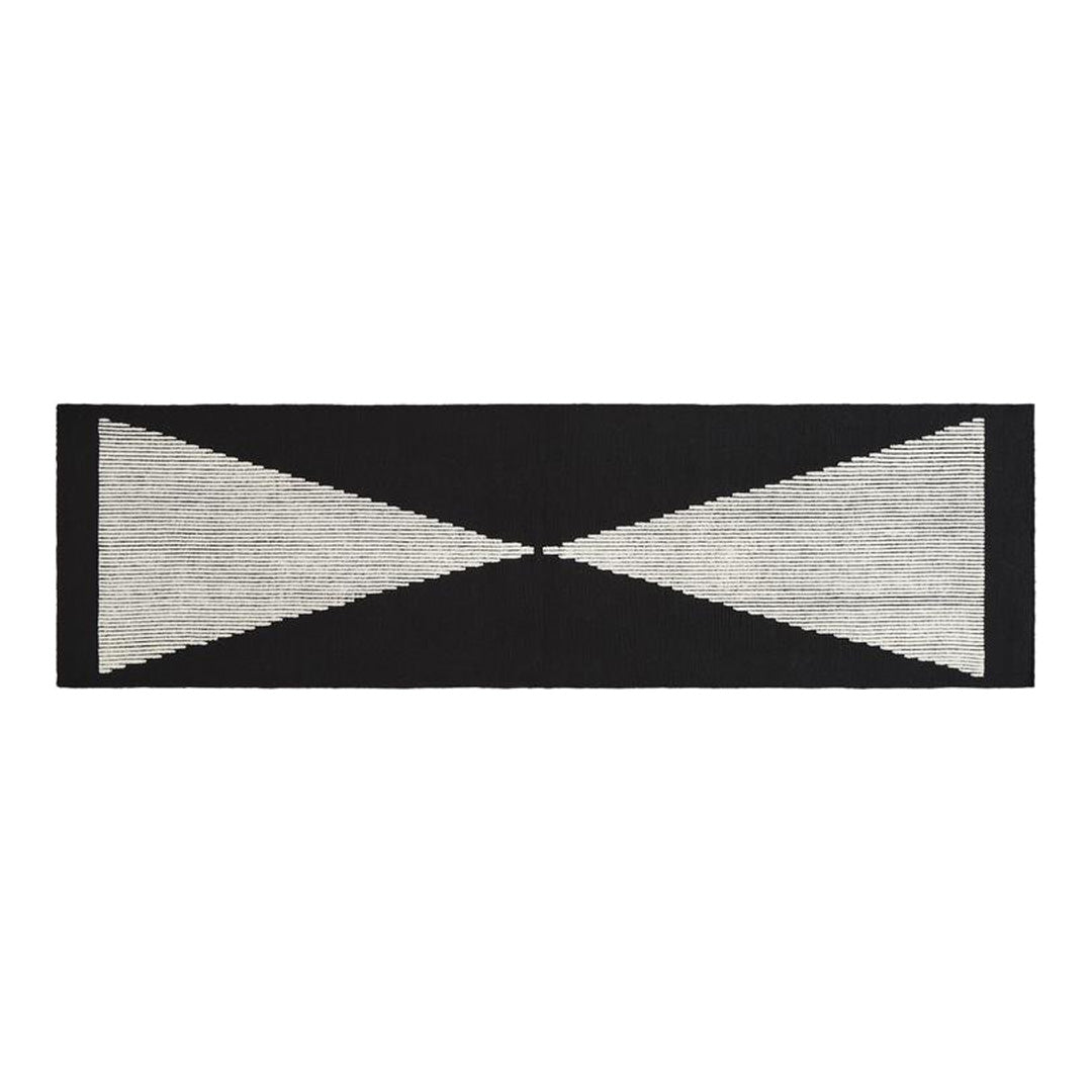 Black and white geometric pattern rug with triangular shapes and horizontal lines, perfect for modern decor.