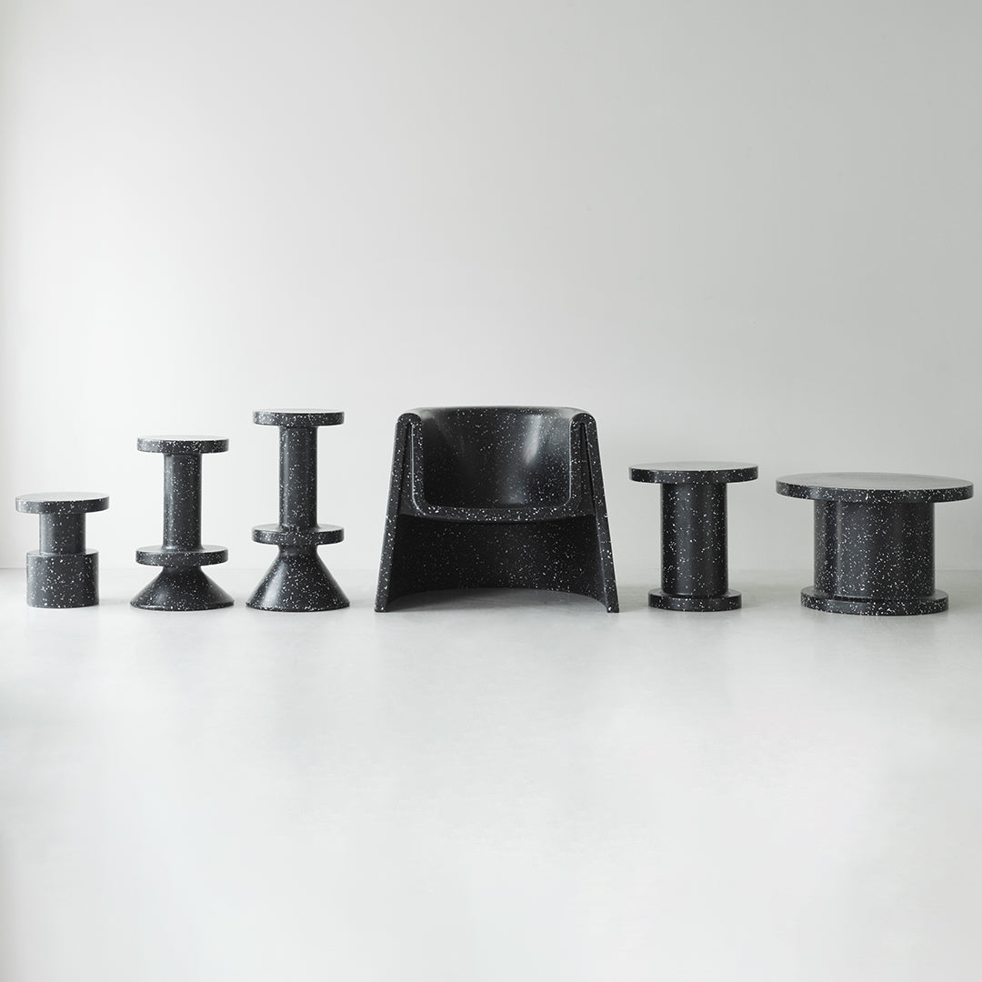 Modern black furniture set featuring various shapes and textures, showcasing sleek patterns and a minimalist design.