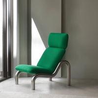 Green upholstered lounge chair with a modern design, featuring a sleek silver frame and minimalist aesthetic.