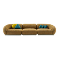 Orange patterned sofa with various colorful pillows in teal, yellow, and blue shapes for a vibrant, modern look.