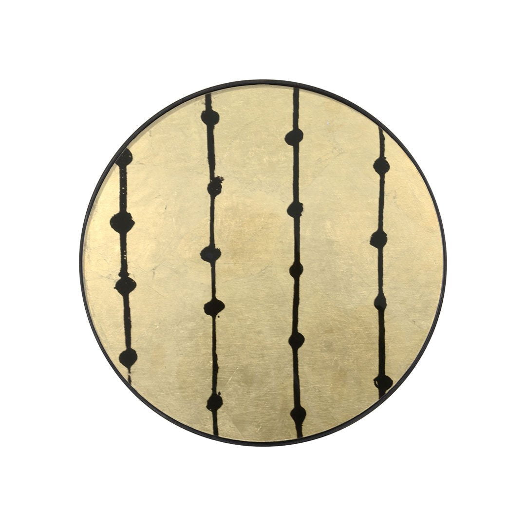 Round decorative plate featuring a gold background with bold black vertical lines and circular accents.
