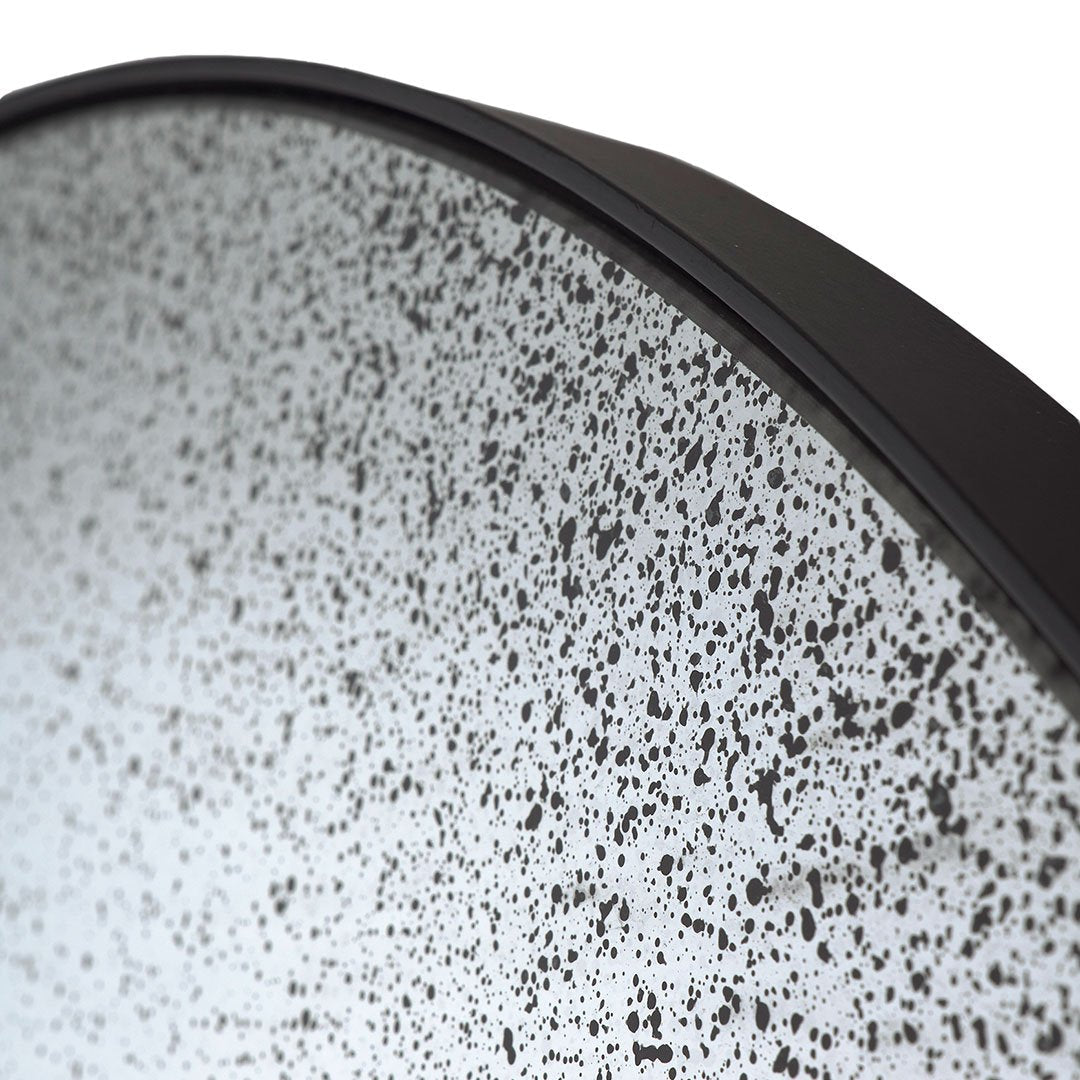 Round plate featuring a speckled black and white pattern with a sleek black edge. Ideal for modern table settings.